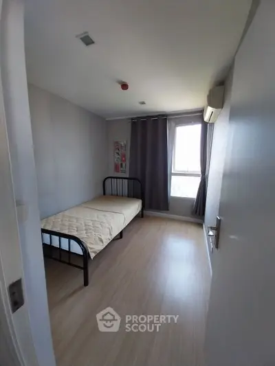 Cozy minimalist bedroom with single bed and natural light