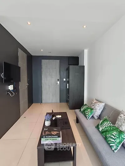 Modern living room with sleek design, featuring a cozy sofa, wall-mounted TV, and stylish decor.