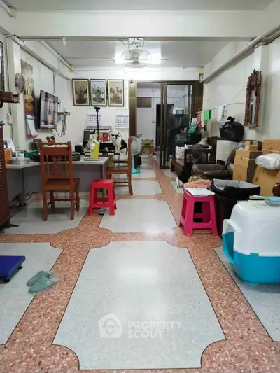 Spacious living room with unique flooring and eclectic decor, ideal for creative home setup.