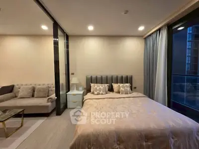 Luxurious bedroom with modern decor and cozy living area in a high-rise apartment.
