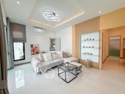 Modern living room with stylish decor and cozy seating area, featuring elegant lighting and contemporary design.