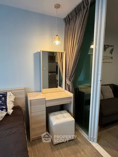 Cozy bedroom corner with modern vanity and plush seating, perfect for relaxation and style.