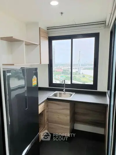 Modern kitchen with sleek design and stunning city view from the window.