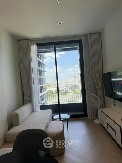 Modern living room with large window and city view, featuring stylish furniture and elegant decor.