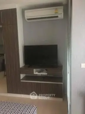 Modern bedroom with built-in TV unit and air conditioning