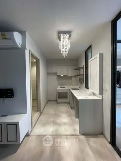 Modern kitchen with sleek design and elegant chandelier lighting