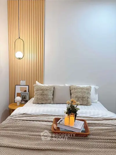 Cozy bedroom with stylish decor and warm lighting, featuring a comfortable bed and elegant accents.