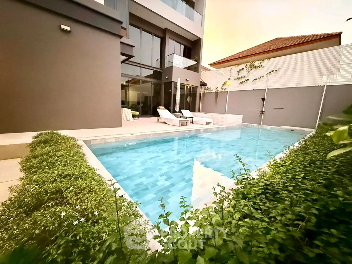 Luxurious modern home with private pool and lush greenery