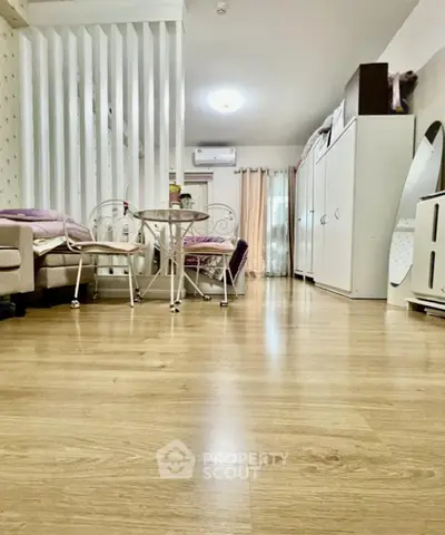 Spacious living room with modern decor and wooden flooring