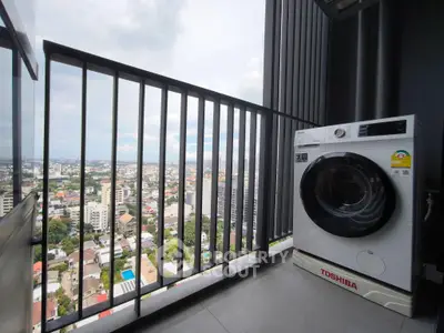 High-rise balcony with city view and washing machine, perfect urban living.