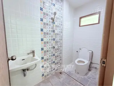 Modern bathroom with colorful tile accents and sleek fixtures