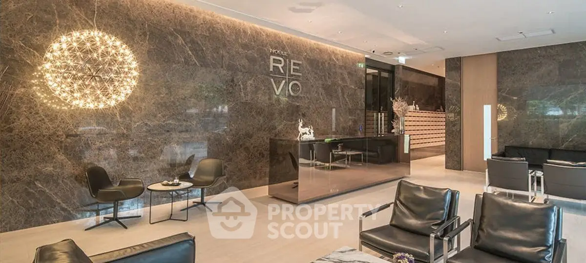 Luxurious modern lobby with elegant seating and stunning lighting in a high-end building.