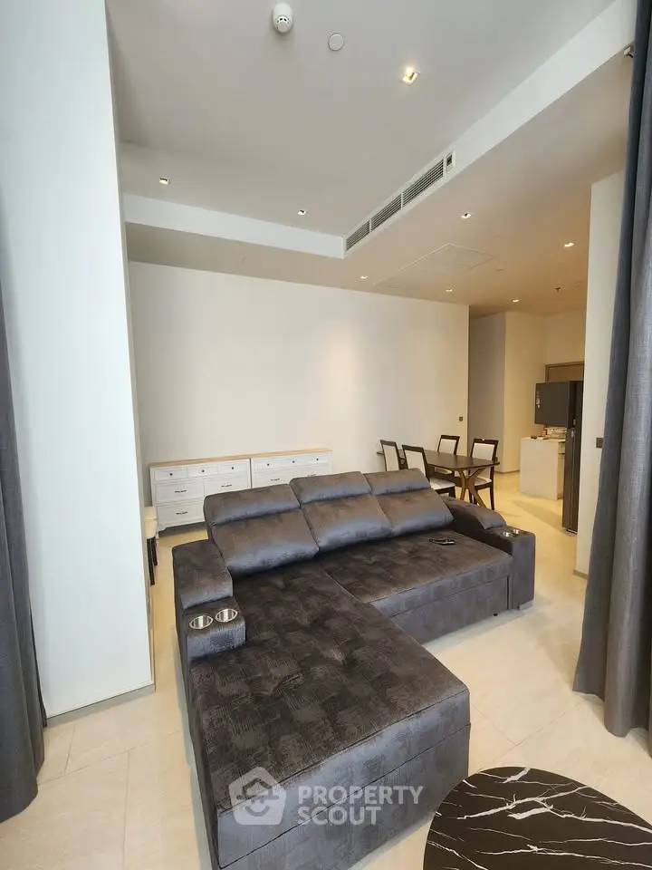 Spacious modern living room with stylish furniture and open layout in luxury apartment.