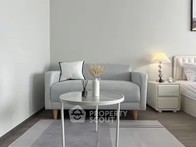 Modern bedroom with stylish gray sofa and elegant decor