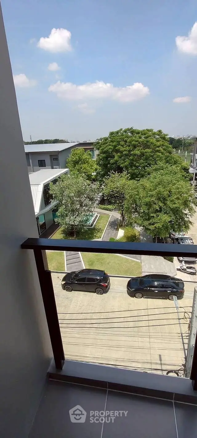 Stunning balcony view overlooking lush greenery and modern architecture, perfect for urban living.