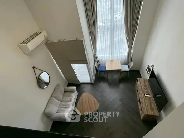 Modern living room with high ceiling and stylish furniture