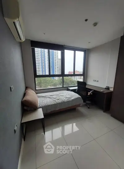 Modern bedroom with large window and city view, featuring sleek furniture and minimalist design.