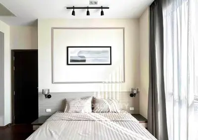 Modern bedroom with elegant decor and large window for natural light