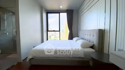 Modern bedroom with city view, featuring a cozy bed and sleek design, perfect for urban living.