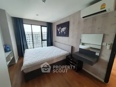 Modern bedroom with large window and stylish decor in urban apartment