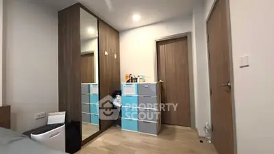 Modern bedroom with mirrored wardrobe and stylish storage drawers