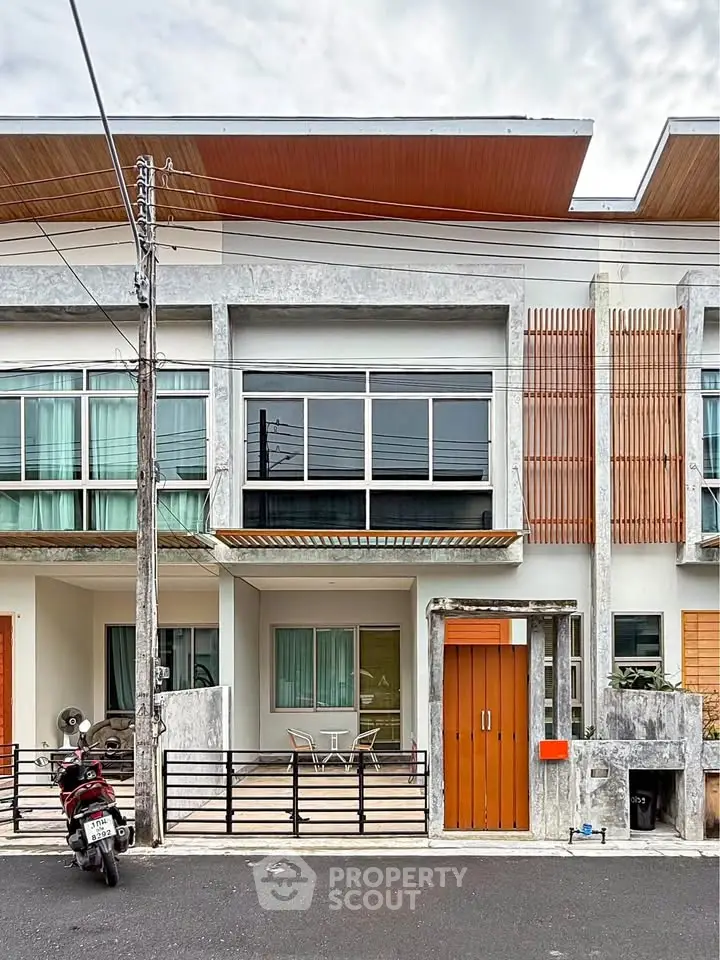Modern townhouse exterior with balcony and stylish facade