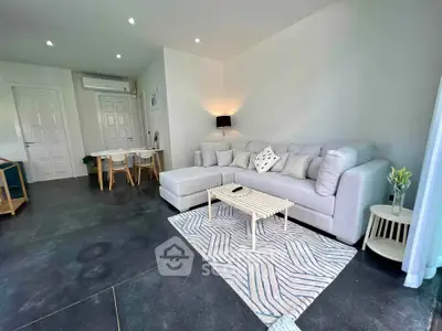 Modern living room with sleek design and cozy furniture in a stylish apartment.