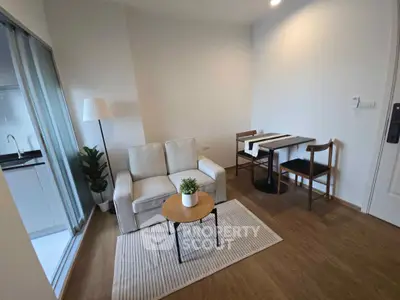 Cozy living room with modern decor and dining area in a stylish apartment.