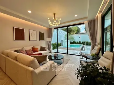 Luxurious living room with pool view, elegant decor, and modern lighting