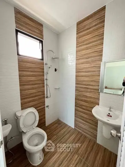 Modern bathroom with wood accent tiles and sleek fixtures