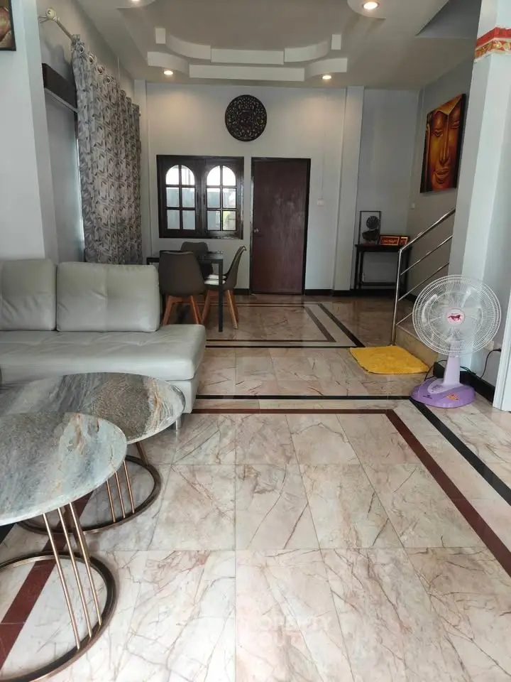 Spacious living room with modern decor and marble flooring