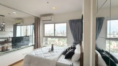 Modern bedroom with city view and glass partition to living area