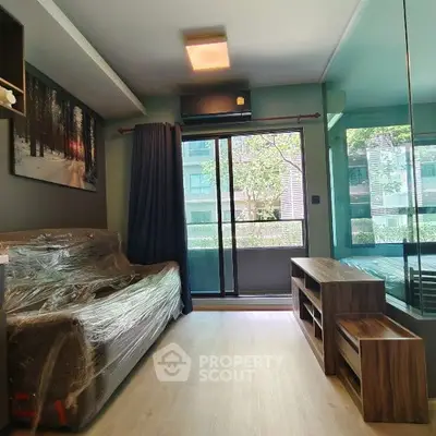 Modern living room with large window and stylish furniture, perfect for urban living.
