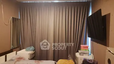 Cozy bedroom with modern decor and wall-mounted TV