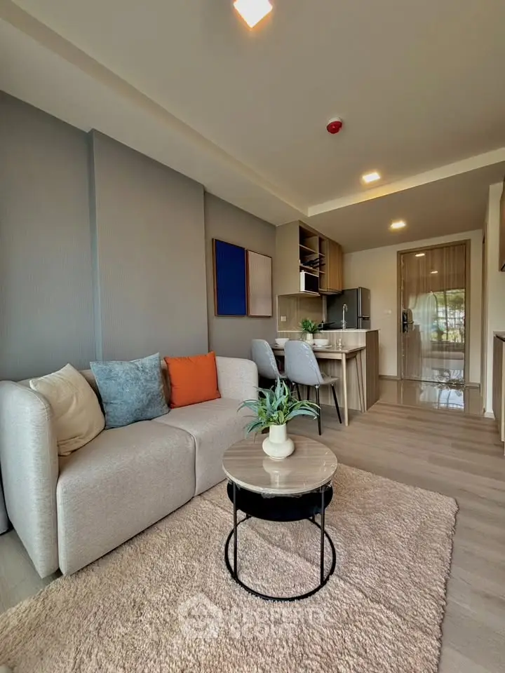 Modern living room with cozy sofa and stylish decor in open-plan apartment