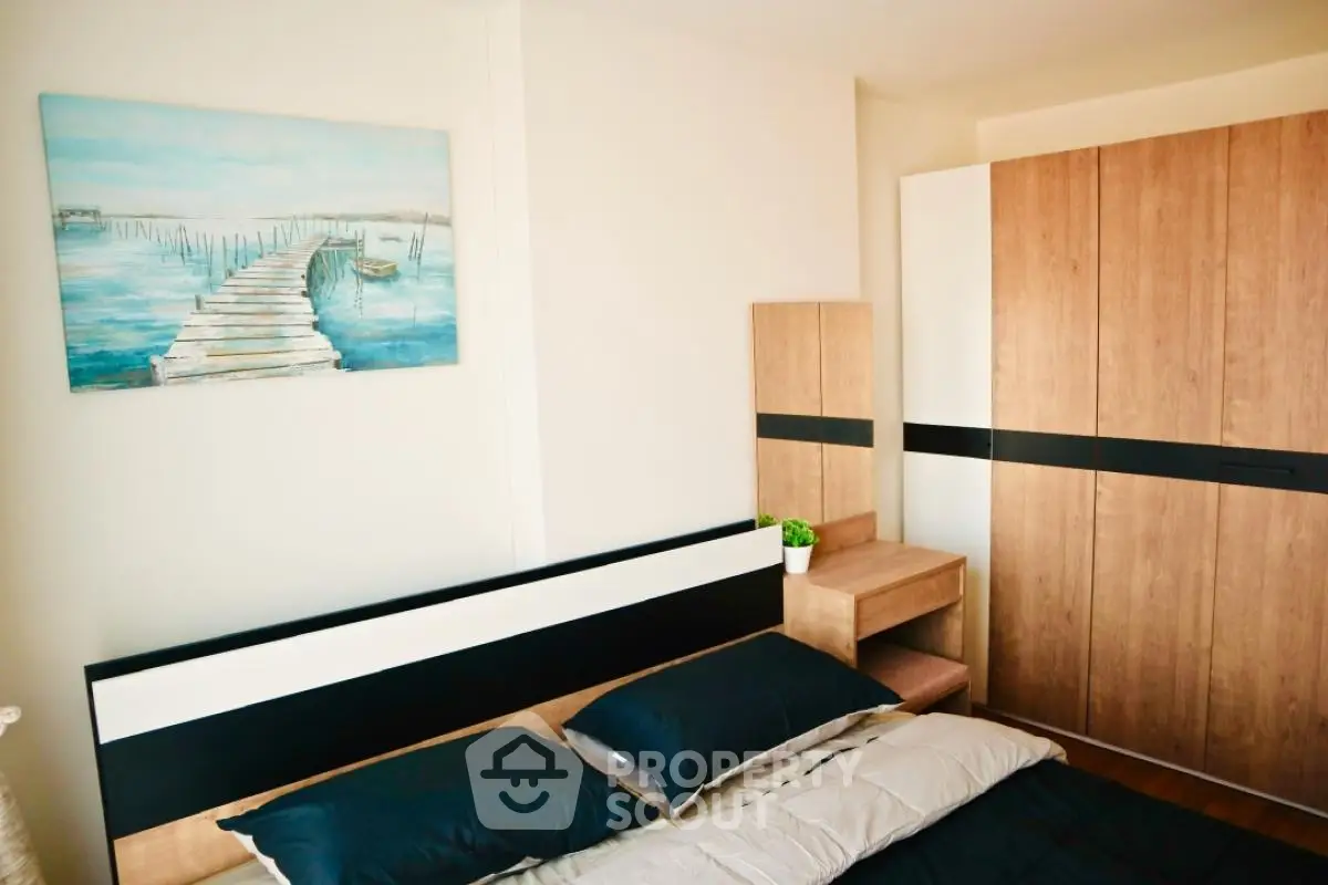 Modern bedroom with stylish wooden furniture and serene wall art.