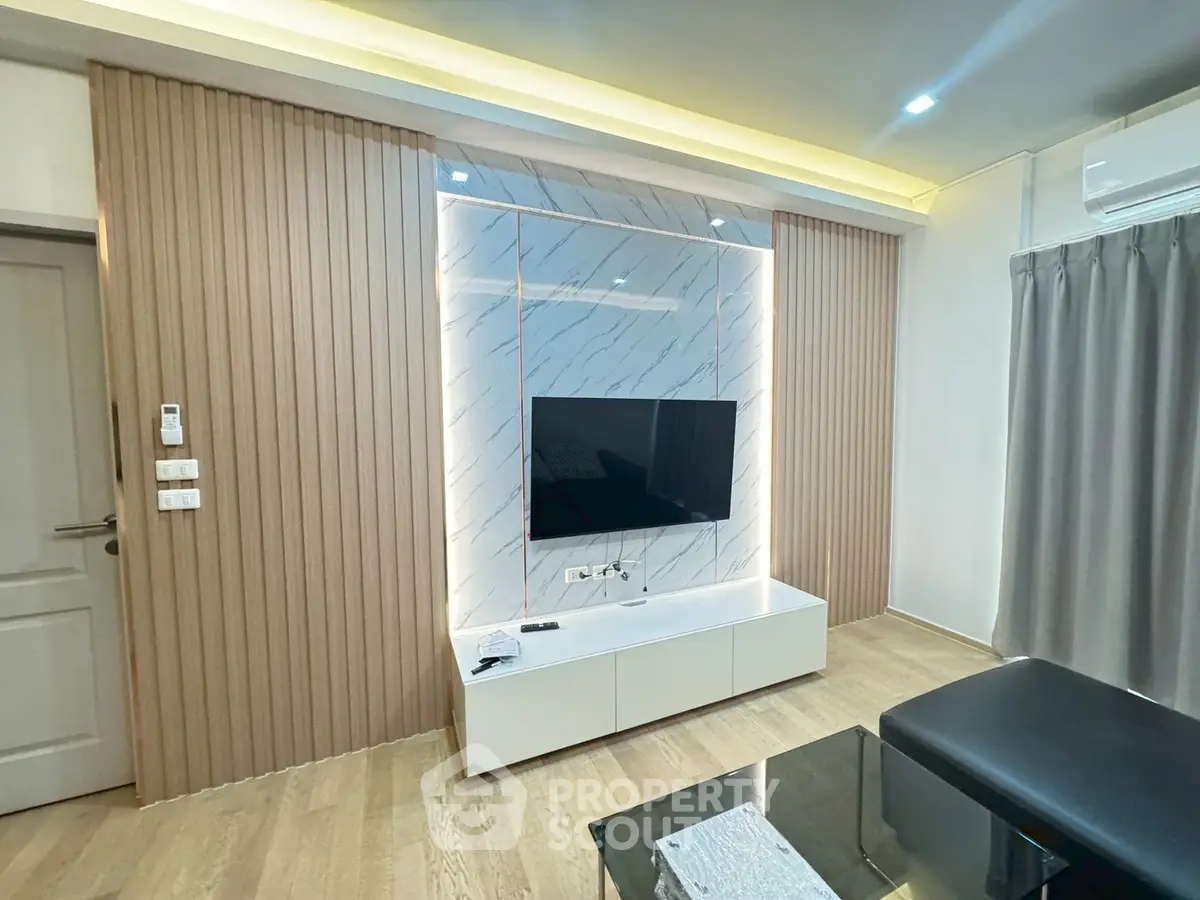 Modern living room with stylish TV wall and sleek furniture