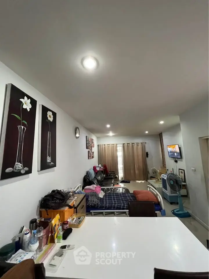 Cozy living room with modern decor and ample natural light, perfect for relaxation and entertainment.