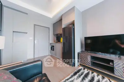 Modern living room with sleek kitchen and stylish decor