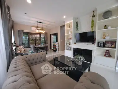 Elegant living room with cozy sectional sofa, modern decor, and built-in shelves in a stylish home.