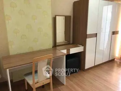 Modern study room with wooden desk and wardrobe in cozy apartment.