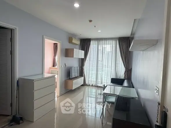 Modern living room with sleek furniture and large windows in a stylish apartment.