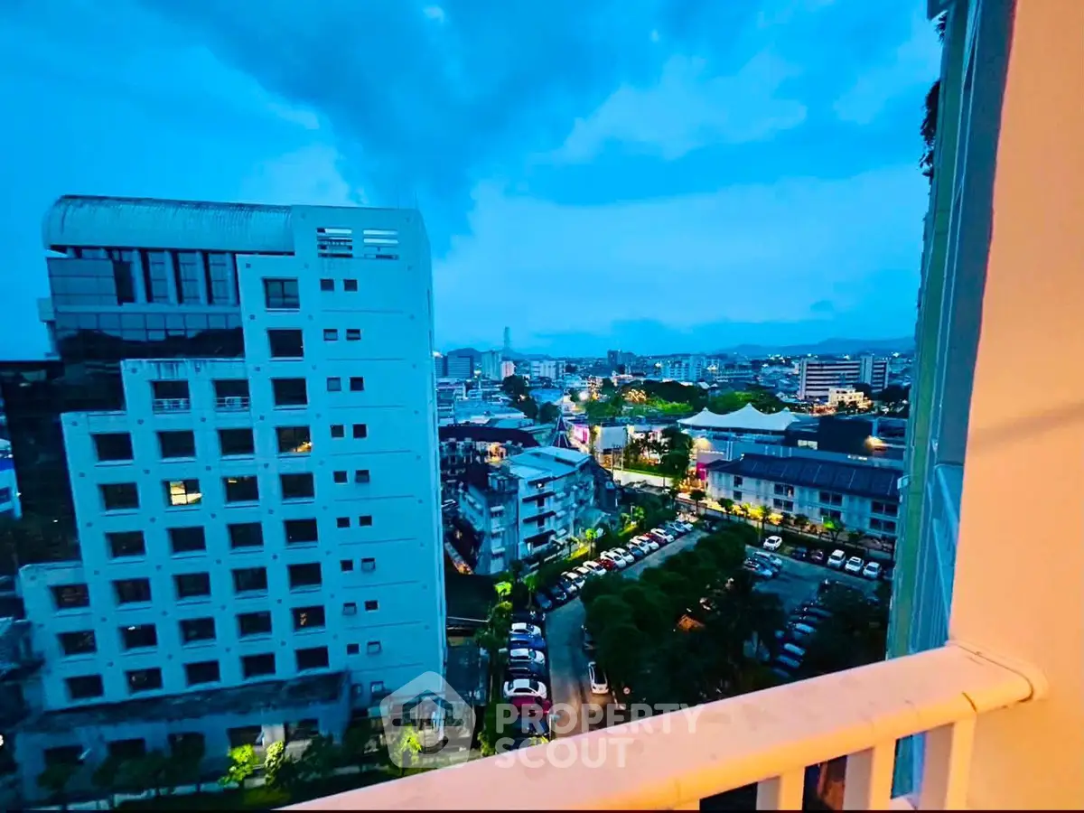 Stunning cityscape view from a high-rise balcony at dusk, showcasing urban living.