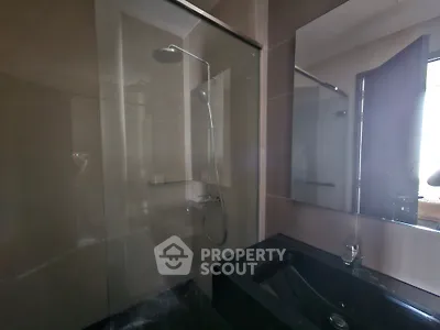 Modern bathroom with sleek shower and dark countertop