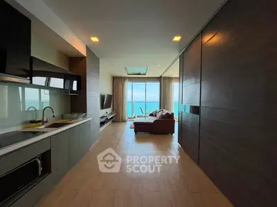 Spacious open-layout living room with ocean view and modern kitchen