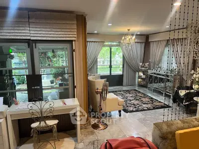 Elegant living room with luxurious decor and large windows overlooking a lush garden.