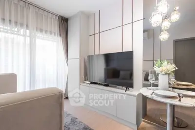 Modern living room with sleek TV setup and elegant dining area