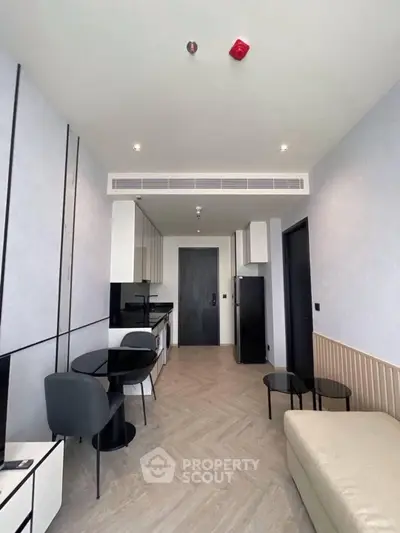 Modern open-layout living room with sleek kitchen and stylish furniture