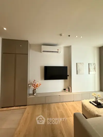 Modern living room with wall-mounted TV and stylish decor