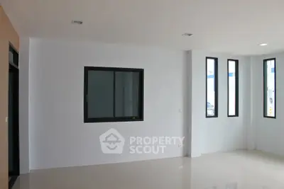 Spacious modern living room with large windows and minimalist design